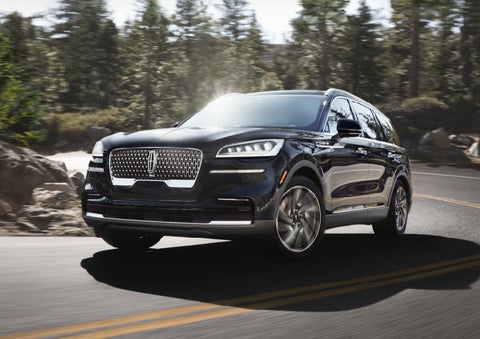 A Lincoln Aviator® SUV is being driven on a winding mountain road | Preston Lincoln in Hurlock MD